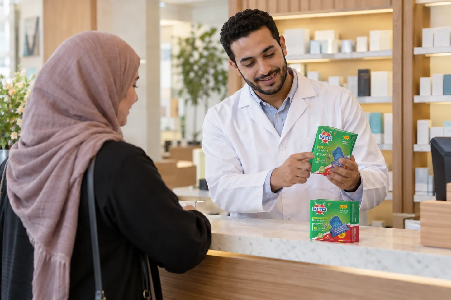 Pharmacist serving a customer, KITO Mats, KITO Powder and KITO Phenic on the counter